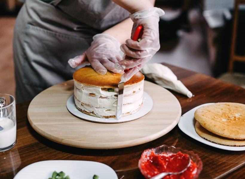 making-cakes-and-desserts-at-home-a-woman-in-disposable-gloves-and-an-apron-cooks-a-cake-.jpg