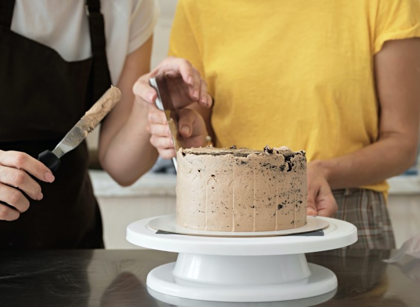 women-couple-making-chocolate-cake-in-kitchen-close-up-cake-making-process-selective-focus.jpg